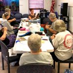 Iuka Librarian, Gwen Spain reads to the Crafty Crafters Knit & Crochet Group.