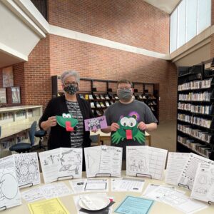 Corinth librarian, Cody Daniel and Assistant Librarian, Amy Alvis showing off our new Spring Activity Packets!