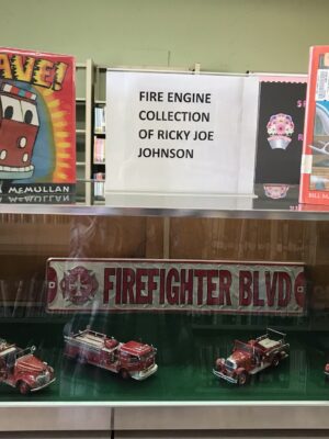 Four antique replica fire engines belonging to Ricky Joe Johnson are on display at the Burnsville Library.
