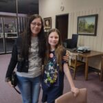 Patrons wearing buttons they designed at the George E Allen Library in Booneville for National Library Week.