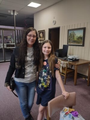 Patrons wearing buttons they designed at the George E Allen Library in Booneville for National Library Week.