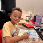 Carter enjoying his Summer Reading Packet!