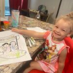 Penelope enjoying her coloring pages in the 5 and under SRP packet from Blue Mountain Library