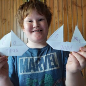 Tishomingo patron Kayden with his craft projects from packet one